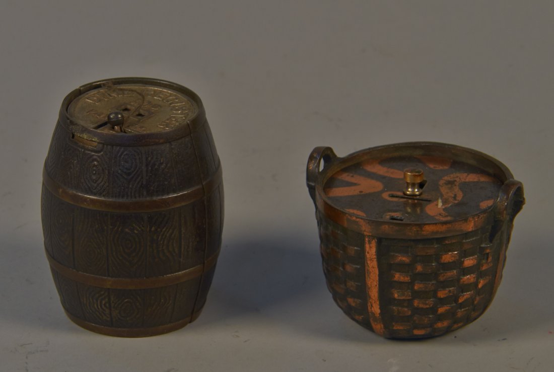 Lot of 2 Cast-Iron Still Banks:: Lot of 2 Cast-Iron Still Banks: 1 - "Dime Register 10 Cents" barrel w/ partial label on bottom - 4"h & 1 - Basket bank w/ copper flash detail - 3"h