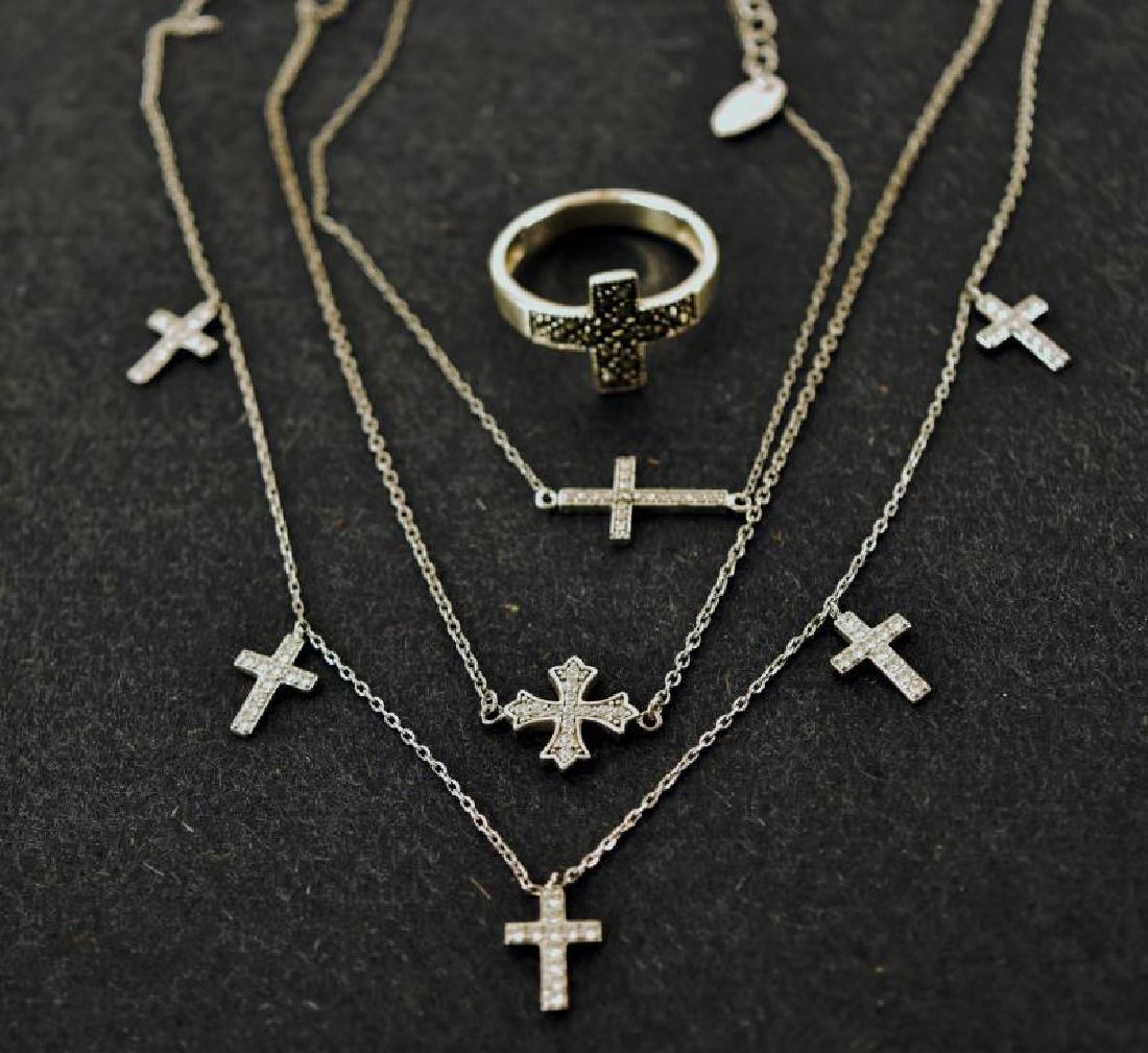 Group Of Sterling Silver Cross Jewelry: Consisting Of Three Necklaces And A Sterling And Marcasite Ring.