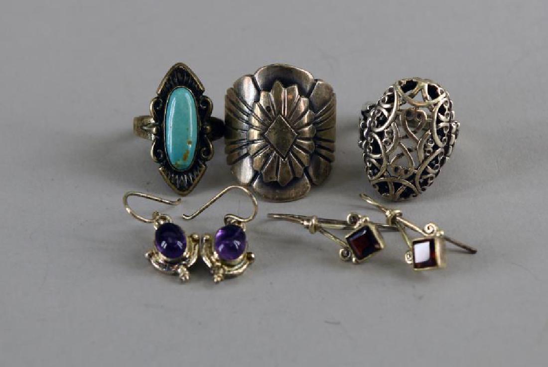 Sterling Silver Rings And Earrings: Consisting Of Two Pair Of Sterling Earrings, Containing Garnets And Amethyst. Together With A Southwest Design Turquoise And Sterling Size 5.5, A Native American Design Ring Marked J. P. Sterling Size