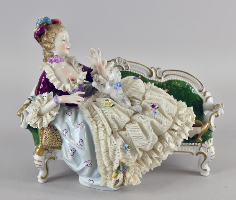Unter Weiss Bach Porcelain Figurine Lap Dog: Featuring The Unter Weiss Bach Figurine Of A Reclining Woman Playing With A Dog On Her Lap. The Figurine Measures 9" Across, 7.5" Tall And 4.75" Deep. There Are No Repairs To The Piece, There Is Missi