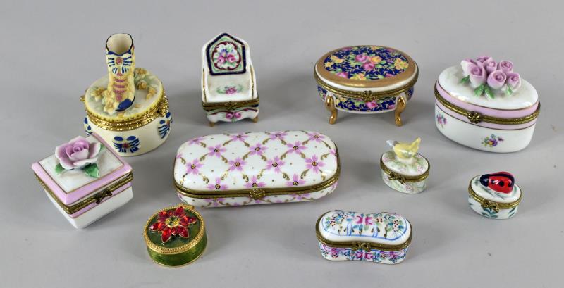 Group Of Porcelain Figural Pill Boxes: Consisting Of Ten Small Porcelain And Metal Pill Boxes And Dresser Boxes. The Largest Is 4.25" Long And 2" Wide, The Smallest Is 1.25" Long And 1" Wide. All Are Unmarked And Are In Good Condition, No 