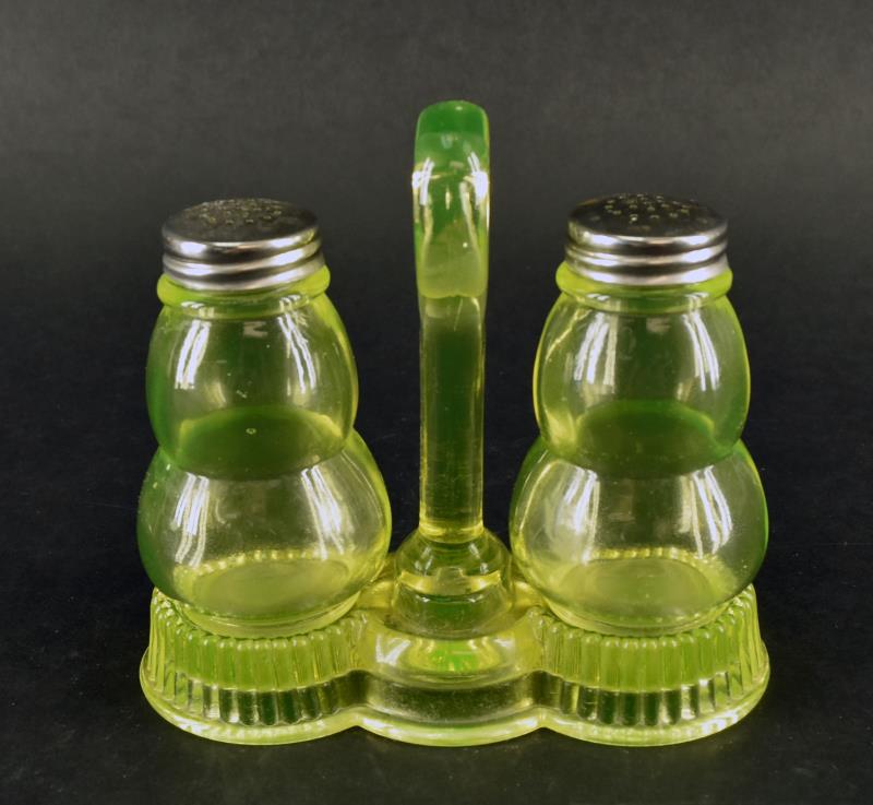Vaseline Glass Salt And Pepper Shaker: An Unusual Vaseline Glass Table Salt And Pepper Shaker Cradled In Carrier. The Set Measures 5.5" Tall And 6" Wide, It Is In Excellent Condition, No Nicks, Chips Or Cracks.