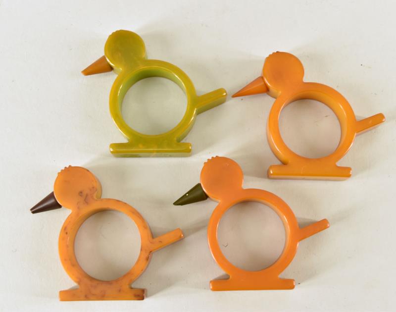 Bakelite Bird Napkin Rings: Consisting Of Four Bird Bakelite Napkin Rings, Three Butterscotch And One Green. All Are Good Condition, The Tip Of The Beak Is Chipped On Three Of Them, No Cracks Or Repairs, Measuring 2.5" Tall And
