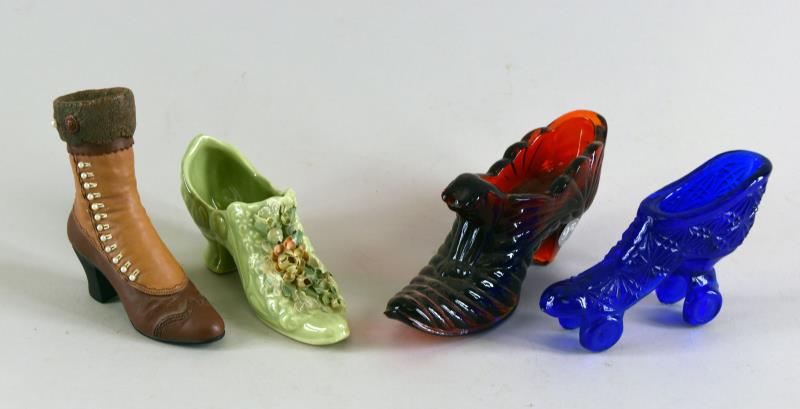Group Of Fenton Glass Shoes And Roller Skates: Consisting Of A Fenton Red Glass Slipper With The Original Fenton Tag, A Cobalt Blue Unmarked Roller Skate, A Porcelain Shoe And A Composition Boot. The Roller Skate Measures 4" Long, 3" Tall And 1" W