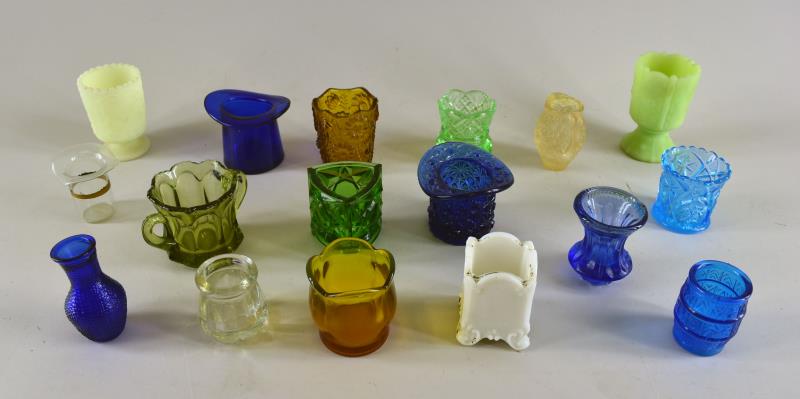 Group Of Seventeen Glass Toothpick Holders: Consisting Of Various Patterns And Colors Of Seventeen Glass Toothpick Holders. The Average Size Is 2.25" Tall And 2" Across. Used Condition.