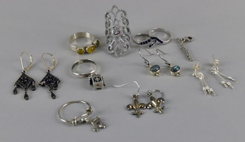 Group Of Sterling Silver Rings & Earrings: Consisting Of 6 Rings, 4 Pairs Of Earrings Including A Marcasite Dangle Set And A Flute Charm.