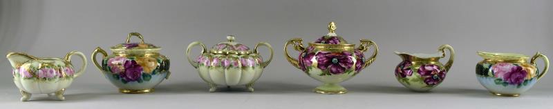 Collection Of Nippon Hand Painted Gold & Roses: Consisting Of Two Sets Of Sugar And Cream By Nippon. Both Are Hand Painted With Gold Gilt, Pink, Red And Yellow Roses. The Pieces Measure 3.5" Tall And 6" Across The Handles. The Pink And Gold Creamer