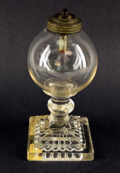 Early Whale Oil Lamp: Featuring A Hand Blown Oil Bulb On A Four Step Pedestal Base. Measuring 7" Tall And A 3.25" Square Base. There Are A Lot Of Waves In The Glass And The Wafer Base, The Underside Edges On The Base Is Ro