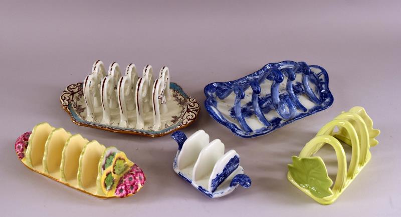 Shelley Blue And White Toast Holder: Featuring A Shelley Toast Holder, Together With Four Additional English Toast Holders. A Carleton Ware, A Copeland, Doulton Burslem And A Royal Winton. The Largest Is The Doulton Burslem Blue And Whit
