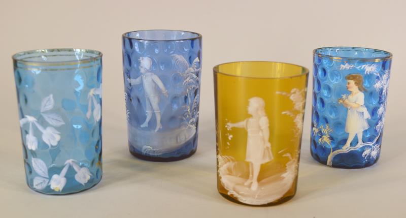 Four Victorian Mary Gregory Tumblers: Consisting Of Three Mary Gregory Tumblers With Girls And Boys In Amber And Blue. Along With One Painted Floral Tumbers In Blue. The Tumblers Average 4" Tall And 2.5" Across. The Three Blue Tumblers Ar