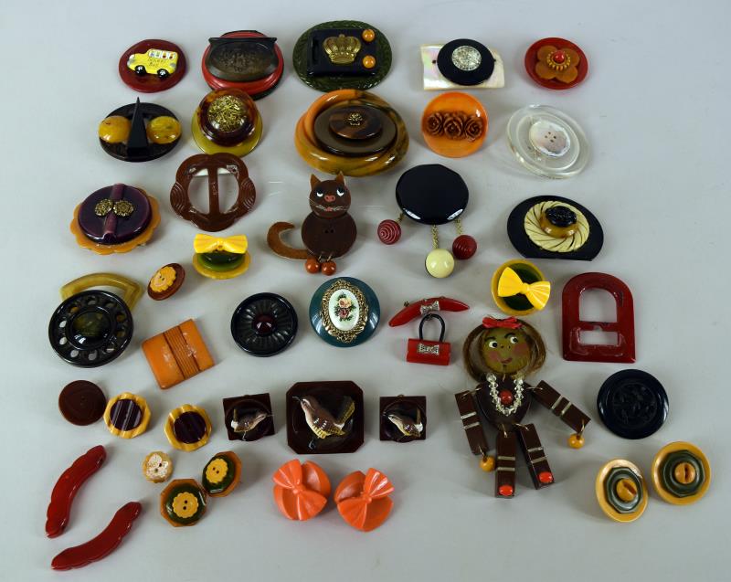 Collection Of Created Bakelite & Acrylic Jewelry: Consisting Of Over 20 Pieces Made From Bakelite Buckles, Buttons And Acrylic Pieces. Several Pieces Are Detached. The Pieces Include Bakelite Wren Pin And Earring Set, Cat Pin, Girl Pin And More.
