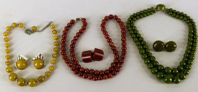 Three Sets Of Bakelite Necklace And Earings: Featuring A Mottled Green, An Olive Green And A Carnelian, All Tested And Guaranteed To Be Bakelite. The Carnelian Measures 24" Long And The Double Stranded Olive Green Measures 15.5" Long. The Earrin