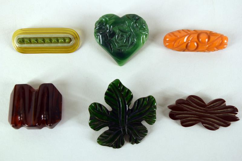 Six Bakelite Pins Or Brooches: Featuring Bakelite Root Beer, Butterscotch, Green And Apple Juice. In Shapes Of Heart, Bar Pin And Leaf. All In Good Condition, Tested And Guaranteed To Be Bakelite, Two Have Had The Back Pin Replaced