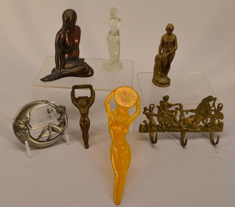 Group Of Nude Art Deco Figures: Featuring A Glass Venus De Milo, Two Patinated Metal Figures, A Plastic Letter Opener Advertising From Rantoul (tip Of Letter Opener Chipped), Bottle Opener, Belt Buckle And A Coat Or Hat Rack. Variou