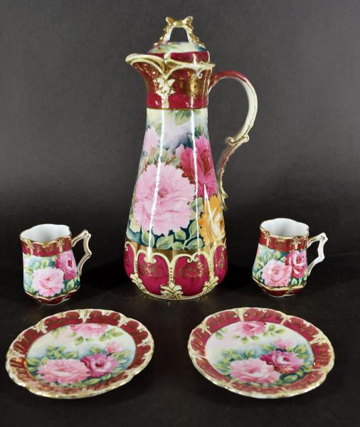 Nippon Gold And Pink Rose Chocolate Set: Consisting Of A Chocolate Pot And Two Cups And Saucer. The Chocolate Measures 11.5" Tall And 5.5" Spout To Handle. In Very Good Condition, No Nicks, Chips Or Cracks. The Saucers Measure Almost 5" Acro