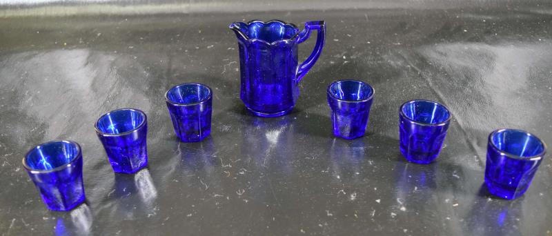 Imperial Glass Cobalt Blue Mini Pitcher & Glasses: Featuring A Miniature Set Of Cobalt Blue Pitcher And Six Small Glasses By Imperial. The Pitcher Measures 3.5" Tall And 4" Spout To Handle, The Glasses Measure 2" Tall And 2" Across. All Are In Good Co