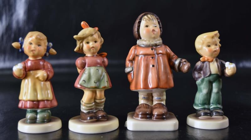 Group Of Four Contemporary Hummels: Featuring #476 Wintersong 1987 Measuring 3 3/4" Tall X 1 1/2" Wide, #564 Free Spirit 1989 Measuring 3 3/4" Tall X 1 1/2" Wide, #2077/b A Flower For You 1999 Measuring 3 1/4" Tall X 1 1/2" Wide And #20