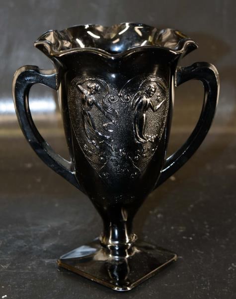 Black Amethyst Trophy Vase: Featuring A Handled Vase With Dancing Girls Measuring 7" Tall X 6" Wide Including Handles. Condition Is Good With No Chips, Nicks Or Cracks.