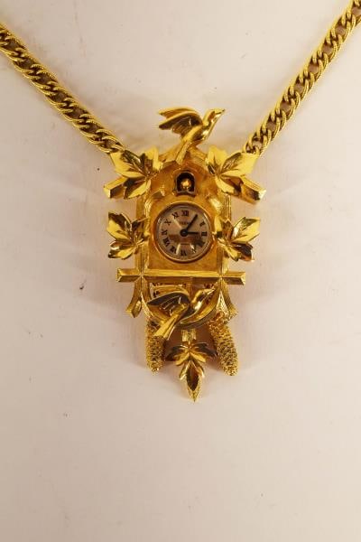 Trifari Cuckoo Clock Necklace: Featuring A Working Trifari Cuckoo Clock Necklace Measuring 27" Chain With An Additional 3" On The Cuckoo Clock. Currently Keeping Accurate Time.