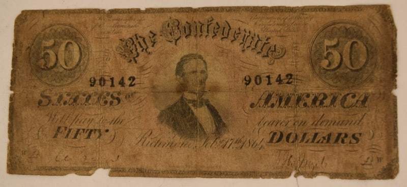 1861 Confederate States Of America $50 Currency: Featuring A 1861 Confederate States Of America, Richmond, $50 Cancelled Note. In Rough Condition.