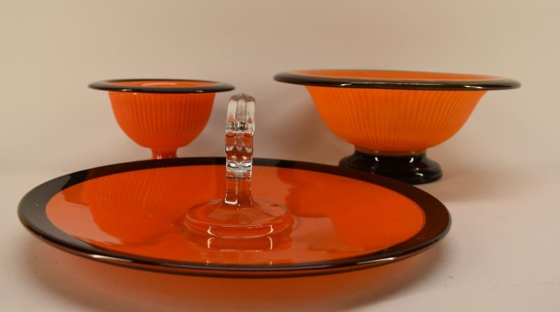 Mid Century Orange & Black Glass Table Articles: Featuring A Center Handle Tid Bit Tray, Pedestal Center Bowl And Dedistal Saucer Bowl. The Larger Center Bowl Has An Internal Crack On The Inside Not Felt On The Outside. The Other Two Pieces Are In G