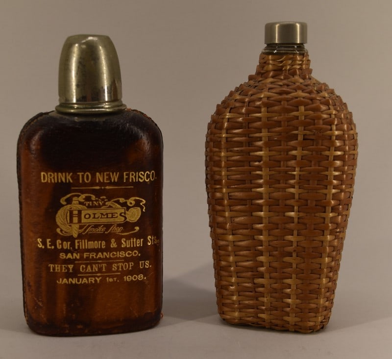 1908 San Francisco Commemorative Flask: Featuring Leather Covered Tiny Holmes Smoke Shop Flask. Commemorating The San Francisco Fire Dated January 1st 1908. The Tin Holmes Smoke Shop Was Located On The Sout East Corner Of Filmore & Sutter S