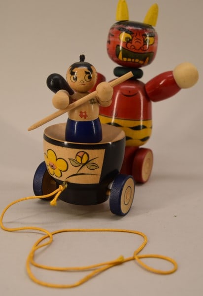 Japanese Issunboshi & The Demon Wooden Toy: Featuring The Wooden Pull Toy Of Issunboshi & The Demon. In Good Condition, Measuring 7" Tall, 6" Long And 3" Deep.