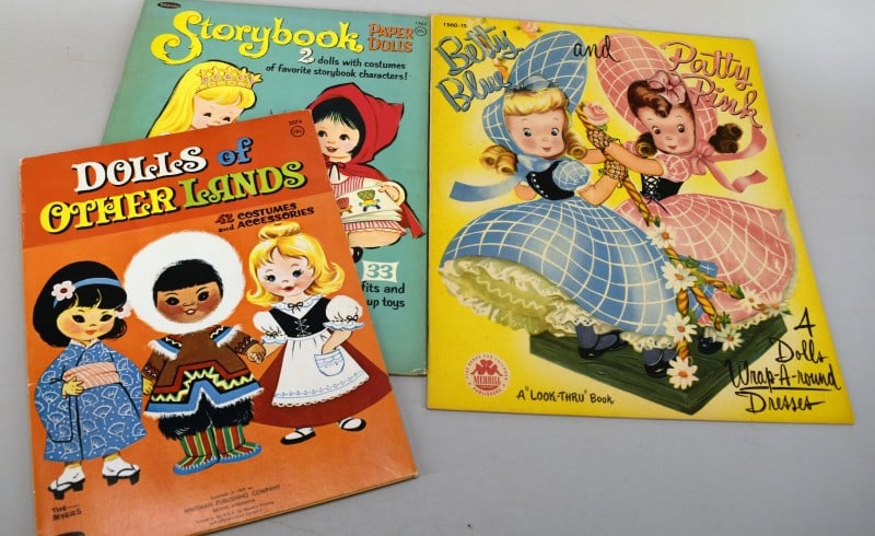 1949 & 1960's Uncut Paper Doll Books: Featuring The 1949 Merrill Betty Blue & Patty Pink Paper Doll Cut Out Book. Complete Consisting Of 4 Dolls With Individual Outfits, Only One Dress Has Been Cut Out And It Is Present And In Good Condit
