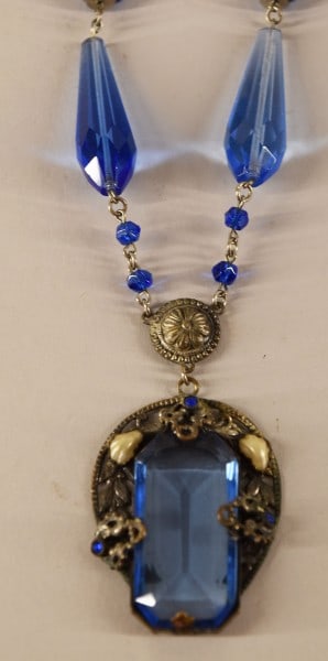 1920's Art Deco Czech Blue Glass Pendant Necklace: Featuring The Czech Blue Glass Drop Pendant In The Art Deco Style. Measuring 16" With A Center Drop Of 2 3/4". In Good Condition.