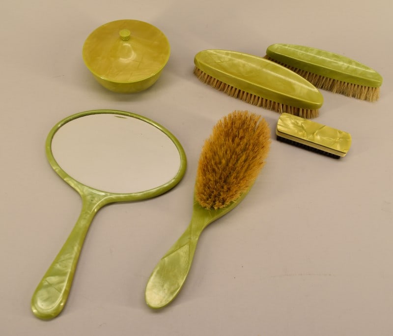 Group Of Mid Century English Celluloid Vanity Set: Featuring A Group Of Green Celluloid Vanity Group Of Brushes, Mirror And Powder Box. Everything But The Shoe Brush Is Marked Made In England, Several Pieces Have The Bristol & Monofil Logo.