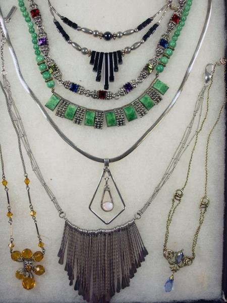 Sterling Silver Kenneth Cole Necklace: Together with a sterling and moonstone necklace, amber bead necklace, hemitite necklace and others.