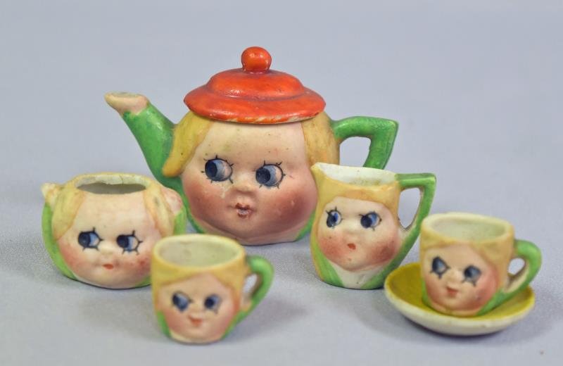 Japan Big Eye Miniature Tea Set: Consisting of a tea pot, creamer, sugar , cup and a cup with saucer.