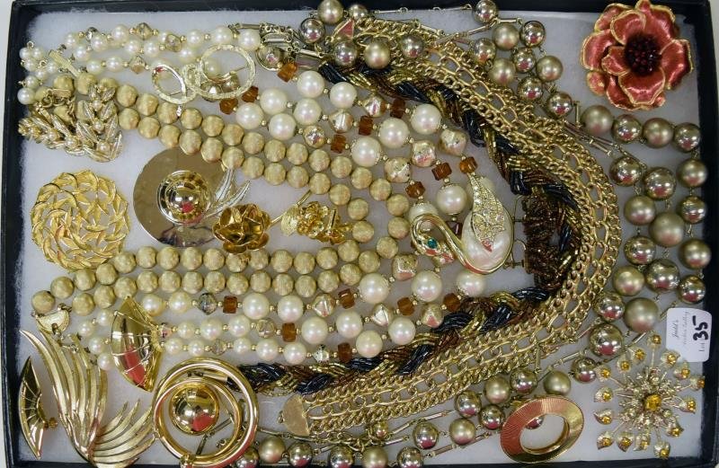 Collection of Goldtone Costume Jewelry: Consisting of brush goldtone necklaces, floral rhinestone pin, Trifari wing free form pin and other vintage necklaces.