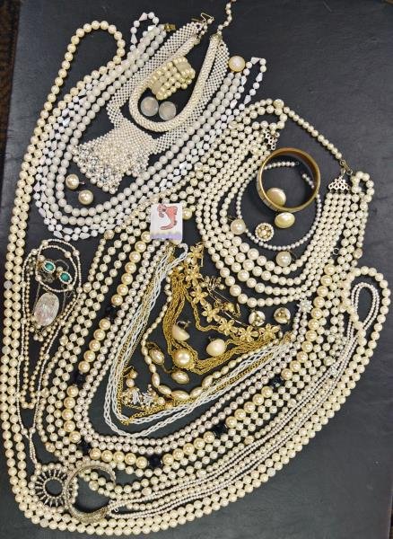 Group of White Pearl Costume Jewelry: Consisting of 13 necklaces, 3 bracelets, 10 earrings and 1 sweater clip