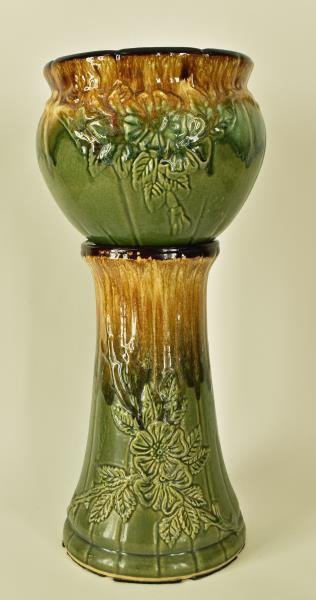 Robinson Ransbottom Jardiniere & Pedestal Featuring a: Featuring a embossed floral design,measuring 22" tall and 9" across. Both pieces are marked R.R. P. Co., Roseville Ohio, the set is in good condition, no nicks, chips or cracks.