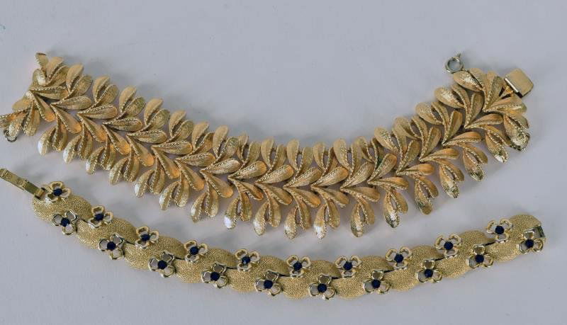 Vintage Goldtone Bracelets The red rhinestone and gold: The red rhinestone and gold bracelet is marked Trifari, the other is unmarked.