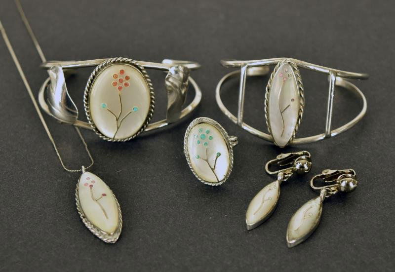 Southwestern Inlaid Mother of Pearl Jewelry Consisting: Consisting of two cuff bracelets, a ring, pendant and pair of earrings. Only the earrings are marked sterling.