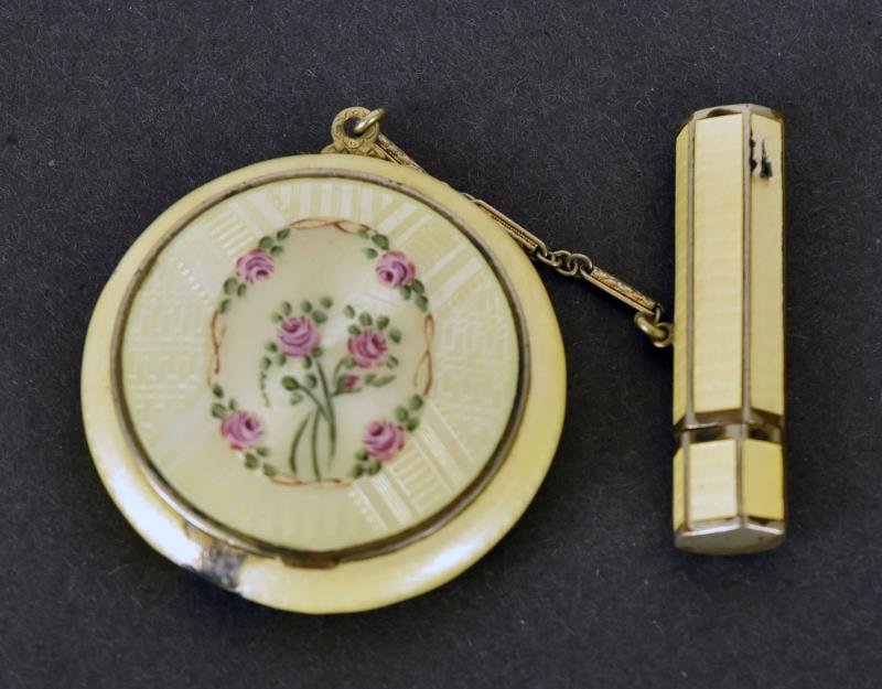 Yellow Enamel Guilloche Compact The compact has a: The compact has a matching attached lip stick. The enamel is damaged, it was well used.