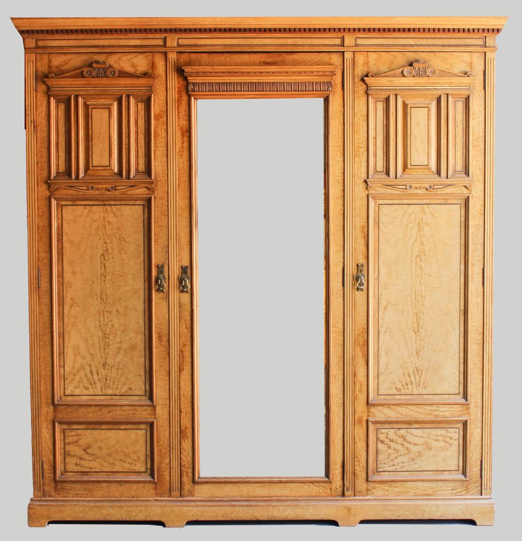 ARTS & CRAFTS FIGURED ASH THREE-PART ARMOIRE, LATE 19TH: ARTS & CRAFTS FIGURED ASH THREE-PART ARMOIRE, LATE 19TH CENTURY with a rectangular dentiled cornice over a conforming case fitted with three doors, the central door with mirror all enclosing a fitted 