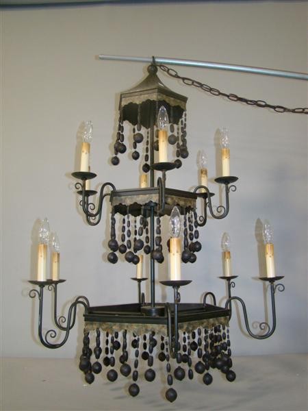 BLACK TOLE & BEAD HUNG TWELVE LIGHT CHANDELIER: The black painted three tier chandelier hung with beads
