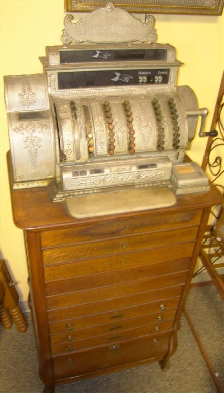 EUGENE JOHNSTON NATIONAL OAK CASH REGISTER: Floor model h: 68 x w: 32 x d: 21 in.