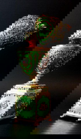 IMPORTANT RUSSIAN SOLID GOLD & ENAMEL EGG: Amazing work of art. Piece is intricately adorned with solid gold in a scrolled design with diamonds set throughout on a green metallic enamel background. The top is in the shape of a crown and is set