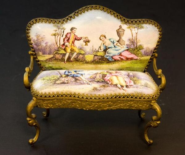 AUSTRIAN METAL ENAMELED MINIATURE SETTEE: Has two courting scenes of men and women near trees. Metal has raised floral design and scrolled arms and legs. Marked Austria to bottom. Measures 2 3/4"" h X 3 1/8"" w X 1 1/2"" d.