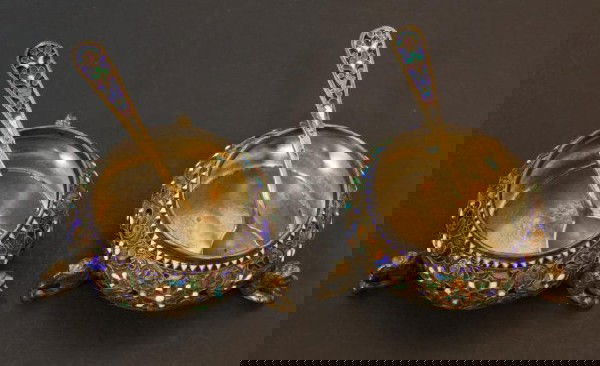 PR NORWEGIAN STERLING SILVER & ENAMEL SALT CELLARS: Have a beautiful multi-color enamel design over silver. Each has 3 figural lion feet. Lot also includes 2 Russian Silver & Enamel Salt Spoons. Spoons have ""AK"" maker's mark. Cellars measure 1 1/8""
