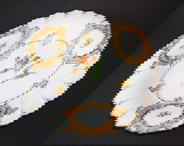 MEISSEN GERMANY HAND PAINTED FLORAL CHARGER: Has a hand painted floral design. Also has an incredible scrolled gilded design. Scalloped edges. Has blue cross swords mark on bottom. Impressed F152a and 58C. Also marked 33. Measures 1 3/4" H x 11