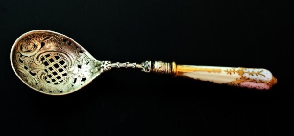 ANTIQUE RICHARD GARTEN GERMAN SILVER PIERCED SPOON: Has antique German hand painted porcelain handle. Silver has beautiful chase work on top and raise floral design to bottom. Bowl has a pierced design. Circa 1880. Weighs 2.290 ounces troy (71.2g). Mea