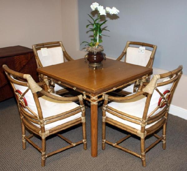 McGUIRE "RATTAN TARGET" TABLE WITH 4 CHAIRS: Pecan oak top table. Table top can swivel and fold out to double in length. Matching pecan oak chairs with suede cushions and rattan corners. Chairs measure 36" H x 17" D x 23.5 W (91.44cm x 43cm x 59