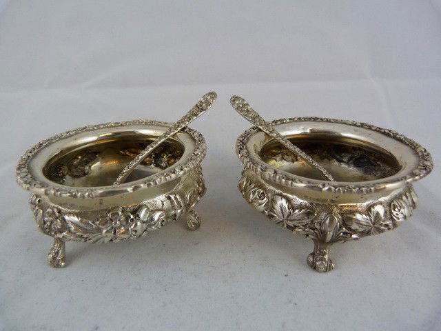 PAIR OF REPOUSSE STERLING SILVER SALT CELLARS: Amazing detail and quality. Fabulous floral repousse design throughout each piece. The set includes the following pieces and measurements: 2 salt cellars: 1 1/2" (4cm) 2 salt spoons: 3 1/4" (8.5cm) Ap