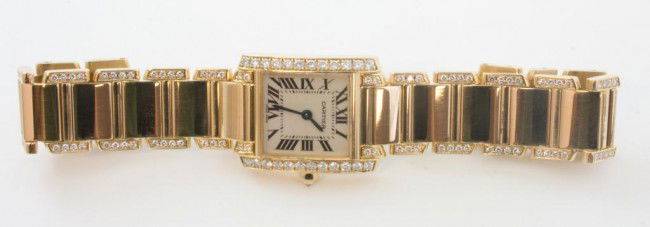 CARTIER 18K YG & DIAMOND TANK WATCH: 18kt Yellow Gold Case & integrated bracelet. Both are accented by diamonds set in 18kt yellow gold. Luminous dial highlights elongated Roman Numerals. Water resistant. Swiss made. Fits up to 6 1/2" wr
