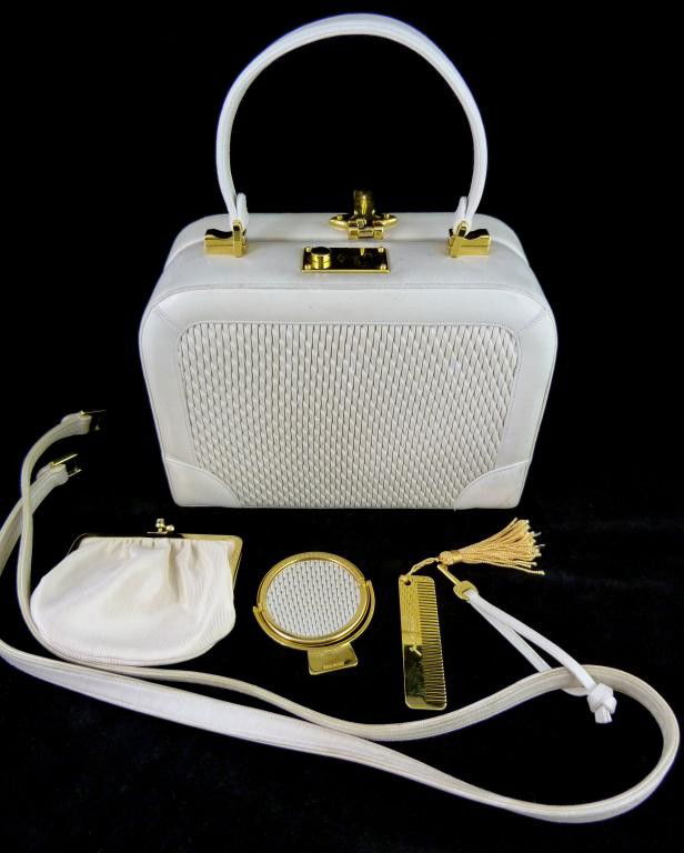 JUDITH LEIBER CREAM LEATHER PURSE: Fabulous Judith Leiber cream leather purse. Has gold hardware with locking clasp. Champagne silk interior. Two pockets to interior. Has detachable strap. Includes Judith Leiber key, coin purse, mirror